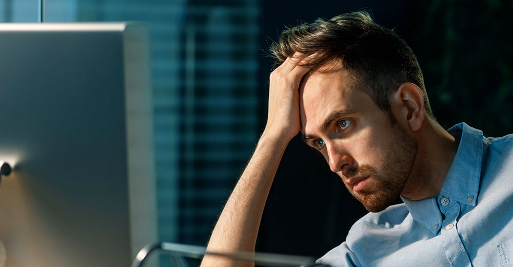Frustrated customer looking at a computer screen during an online support or shopping experience