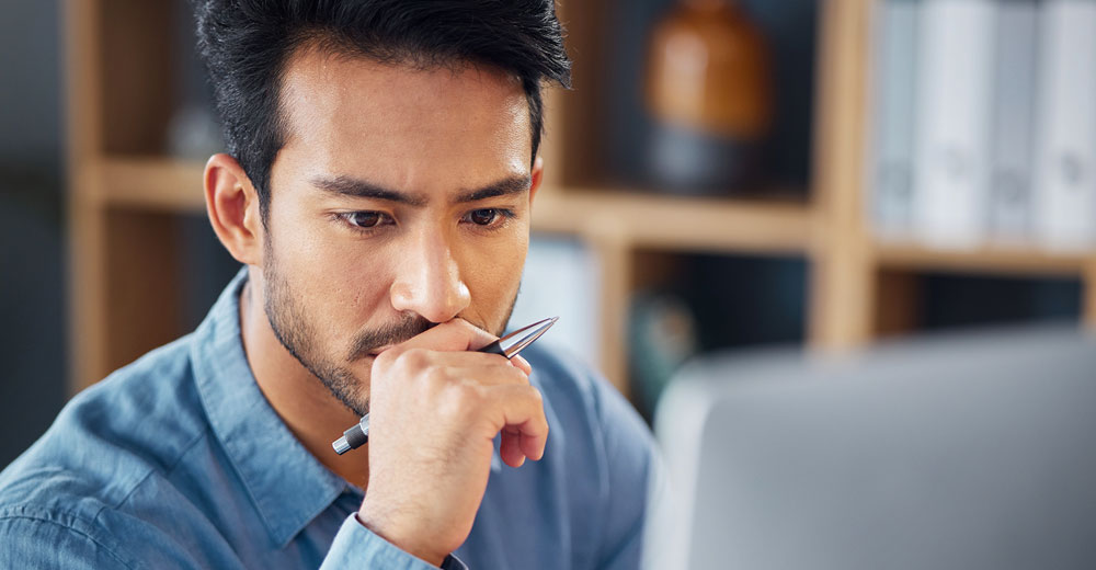 Business professionals reviewing enterprise software on a desktop while discussing procurement decisions
